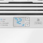Digital control panel below an air conditioning unit's front grille.