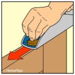 Drawing of a man's hand planing a door, including direction of movement.