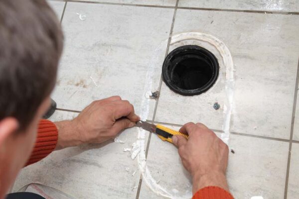 removing old caulk below toilet