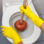 plunging a clogged toilet