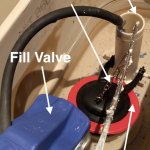 inside toilet tank showing flapper fill valve chain and overflow tube
