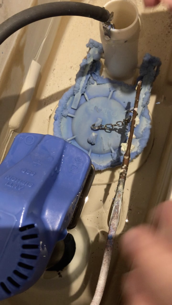worn toilet flapper inside toilet tank