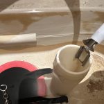 proper position of refill tube above the overflow tube in toilet tank