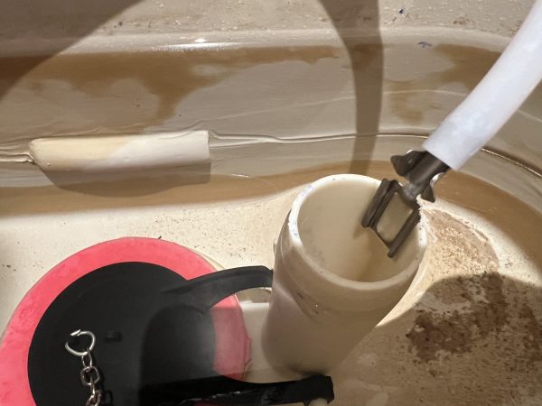 proper position of refill tube above the overflow tube in toilet tank