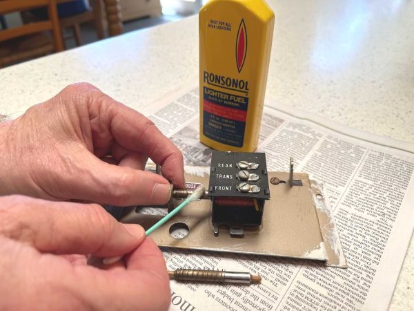 clean doorbell plunger with lighter fluid