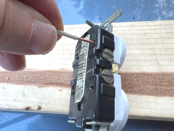 Wire is pushed into hole in receptacle for a backstabbed connection